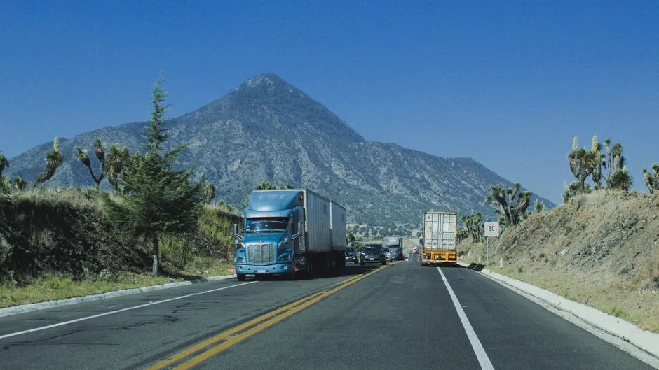 Semi trucks on a scenic mountain highway, the kind of combination vehicle a Class A CDL authorizes