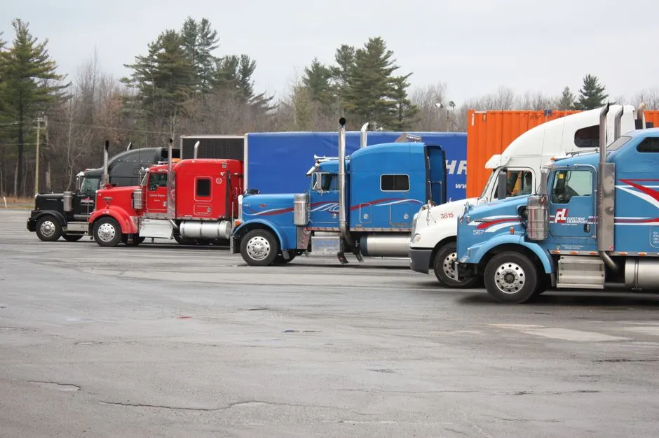 Semi trucks parked in an open lot, illustrating the commercial trucking industry