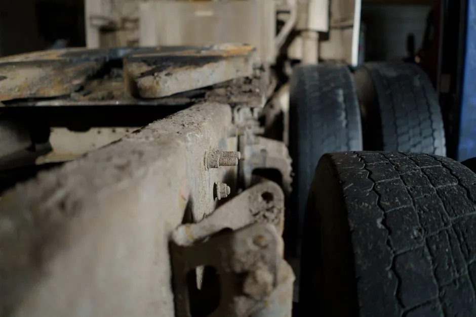 Close-up of a truck chassis, wheels, and air-brake components underneath a commercial vehicle